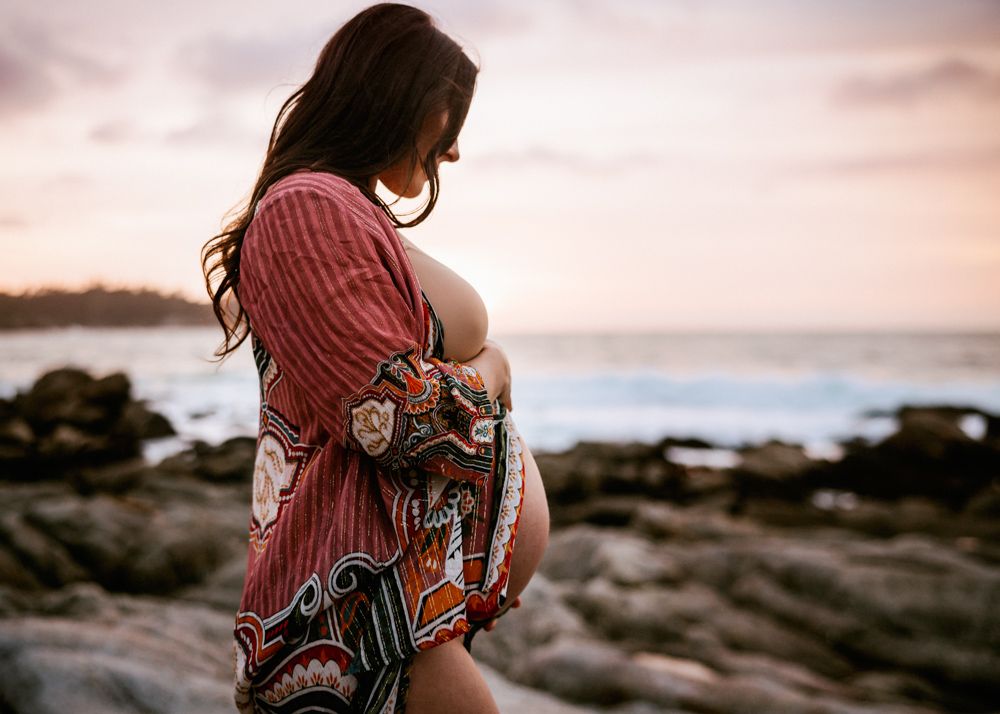 maternity session in carmel california with bohemian momma embracing her belly