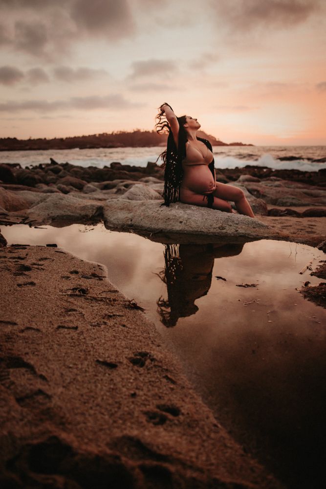 Artistic reflection shot in tidal pools along rocky beach at sunset.