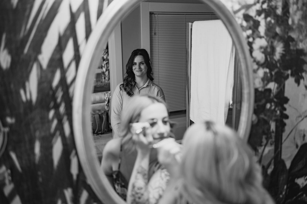 Black and white reflection in an ornate mirror showing shadows and architectural details.