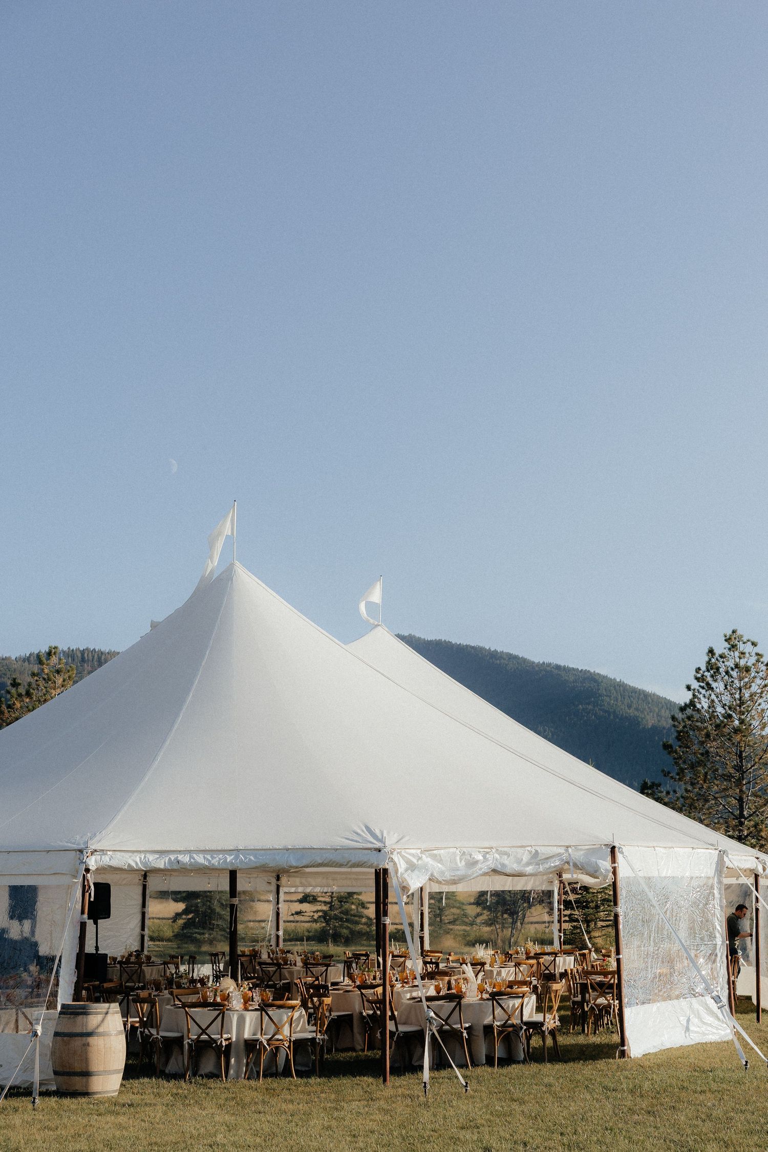 A tender embrace in a wildflower meadow surrounded by mountain scenery.