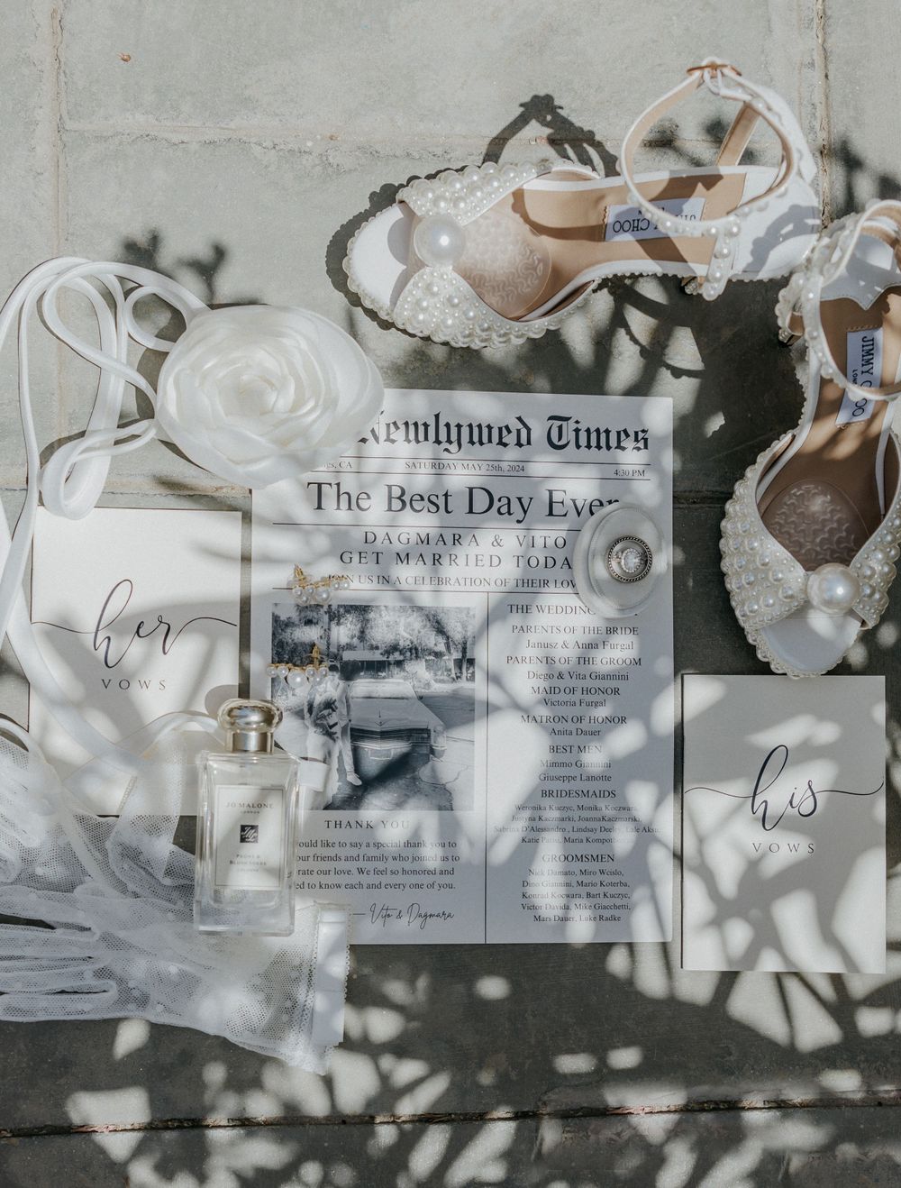 Wedding details flatlay with newspaper, shoes, and decorative elements in soft lighting.