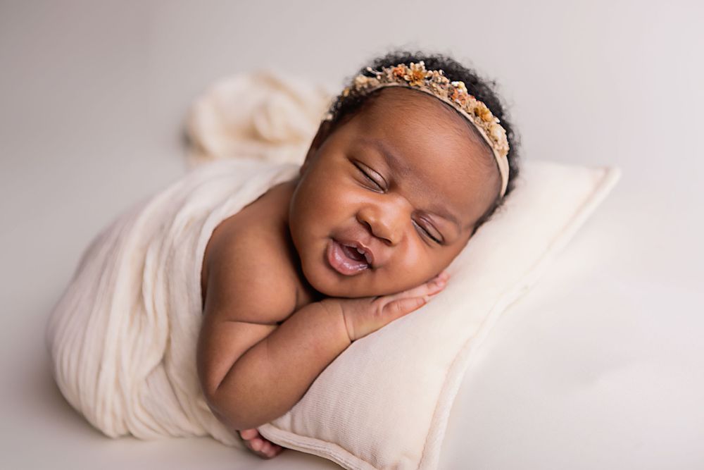 newborn baby smiling