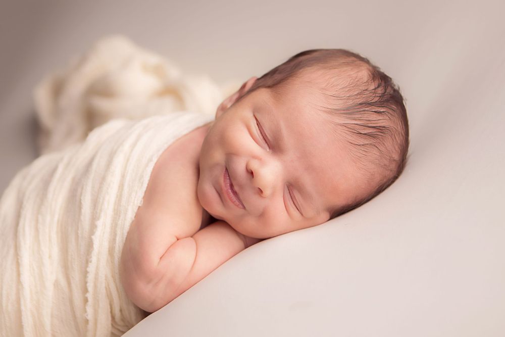 newborn baby smiling
