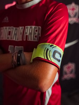 Close-up shots showing a red cycling jersey sleeve with a neon yellow and black arm band detail.