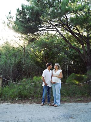 Romantic couple sharing intimate moments together in a pine forest setting.