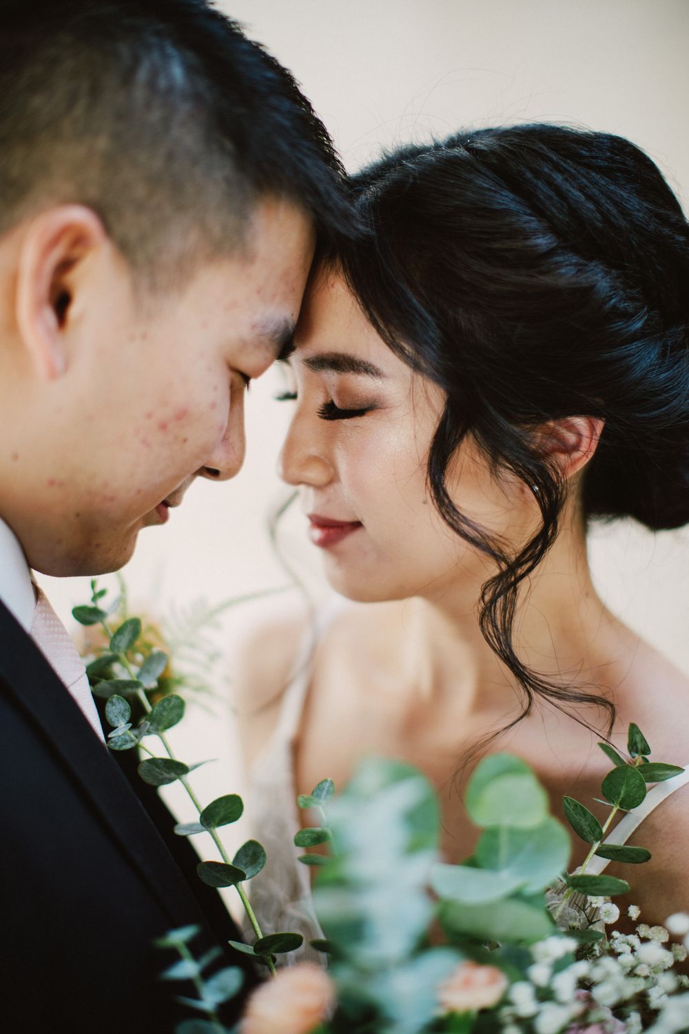 An intimate wedding portrait with eucalyptus and floral details.