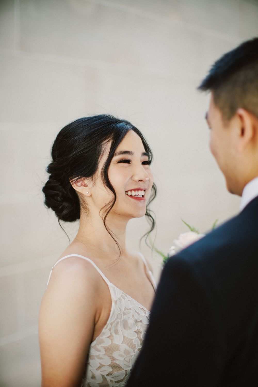 A candid wedding moment captured in a bright, elegant setting.