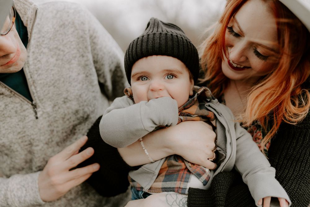 Candid moment of joy with a baby being held and cuddled.