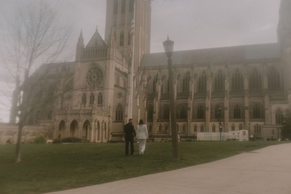 A Gothic cathedral with ornate architecture appears in a misty, atmospheric setting.