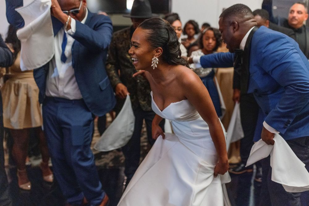 Wedding reception celebration with dancing and live music performance.
