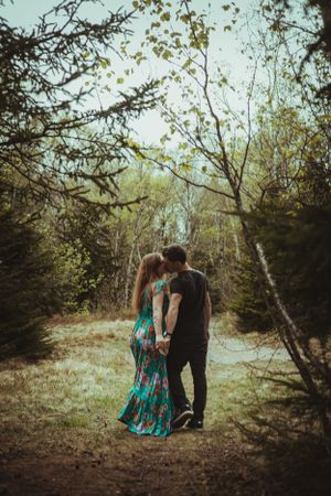 A couple walking through a dreamy forest landscape.
