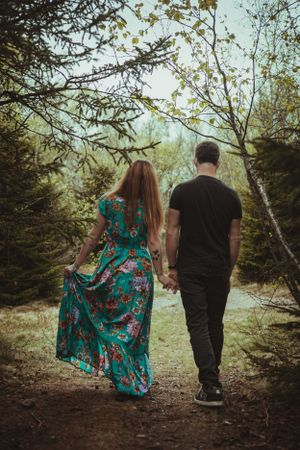 A romantic forest walk featuring a flowing turquoise dress.