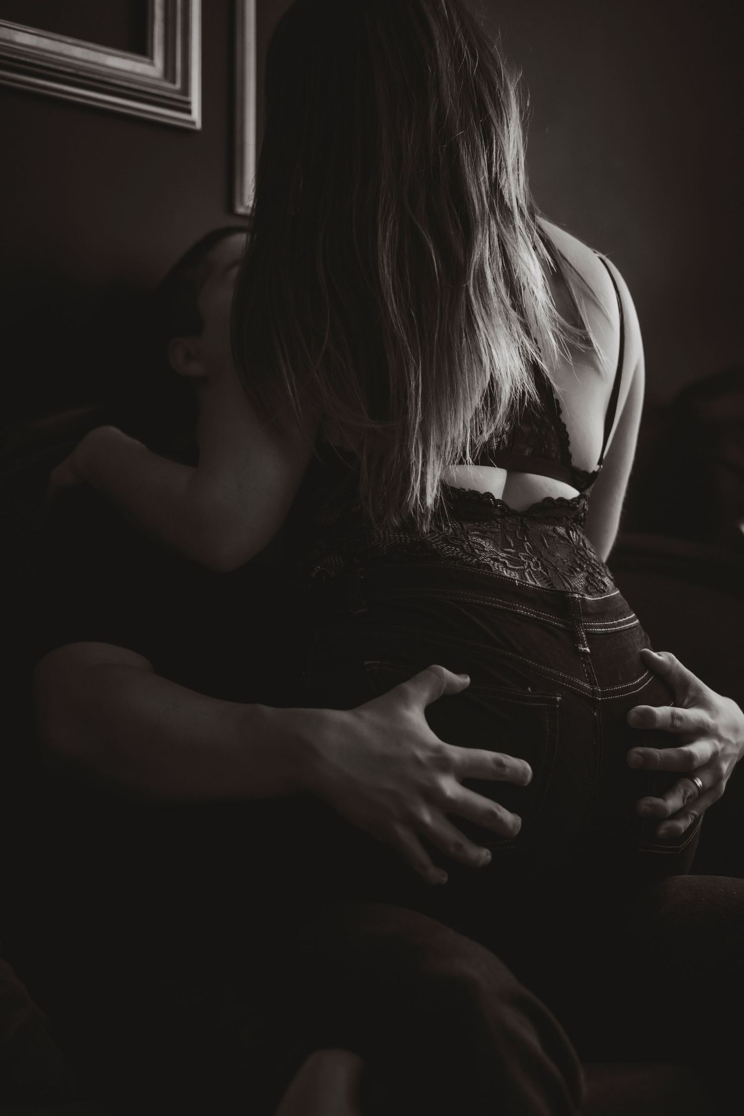 A dark and moody series of black and white couples photos with the couple embracing in low light.