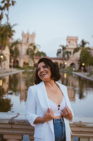Natural candid moment captured by ornate balustrade with Spanish architecture and palm trees.