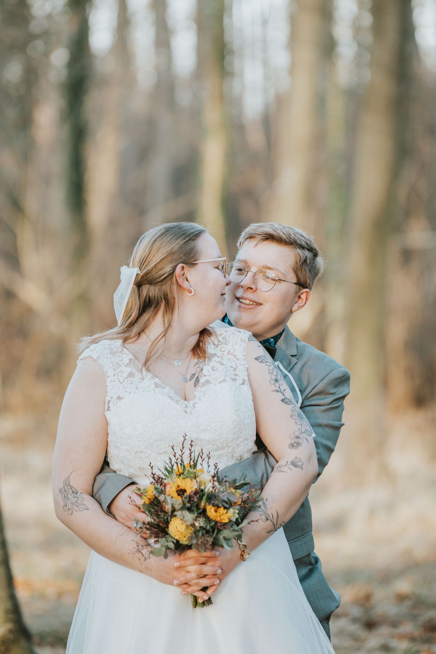 Intimate wedding photos captured in a forest setting with sunflowers in the bridal bouquet.