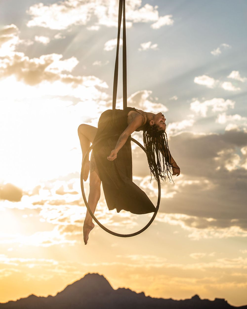 Professional aerialist photoshoot on Utah Salt Flats; aerialist on lyra in aerial arts photography and aerial portraits.