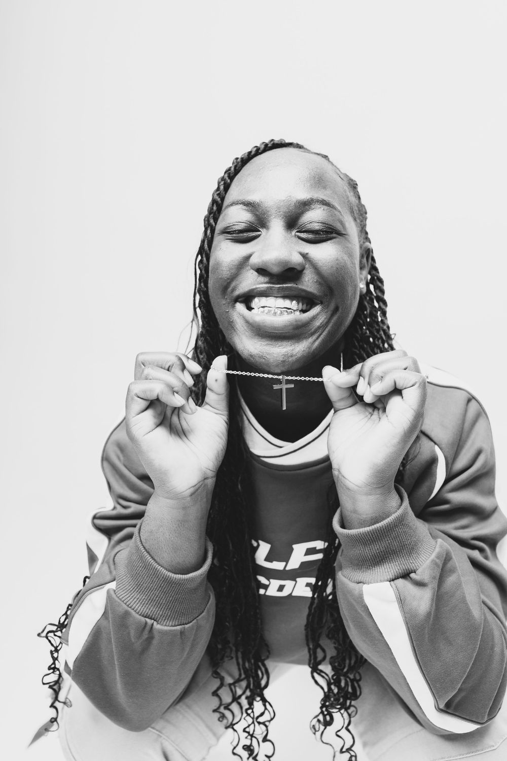 Black and white portrait series showing joyful expressions and silver necklace.