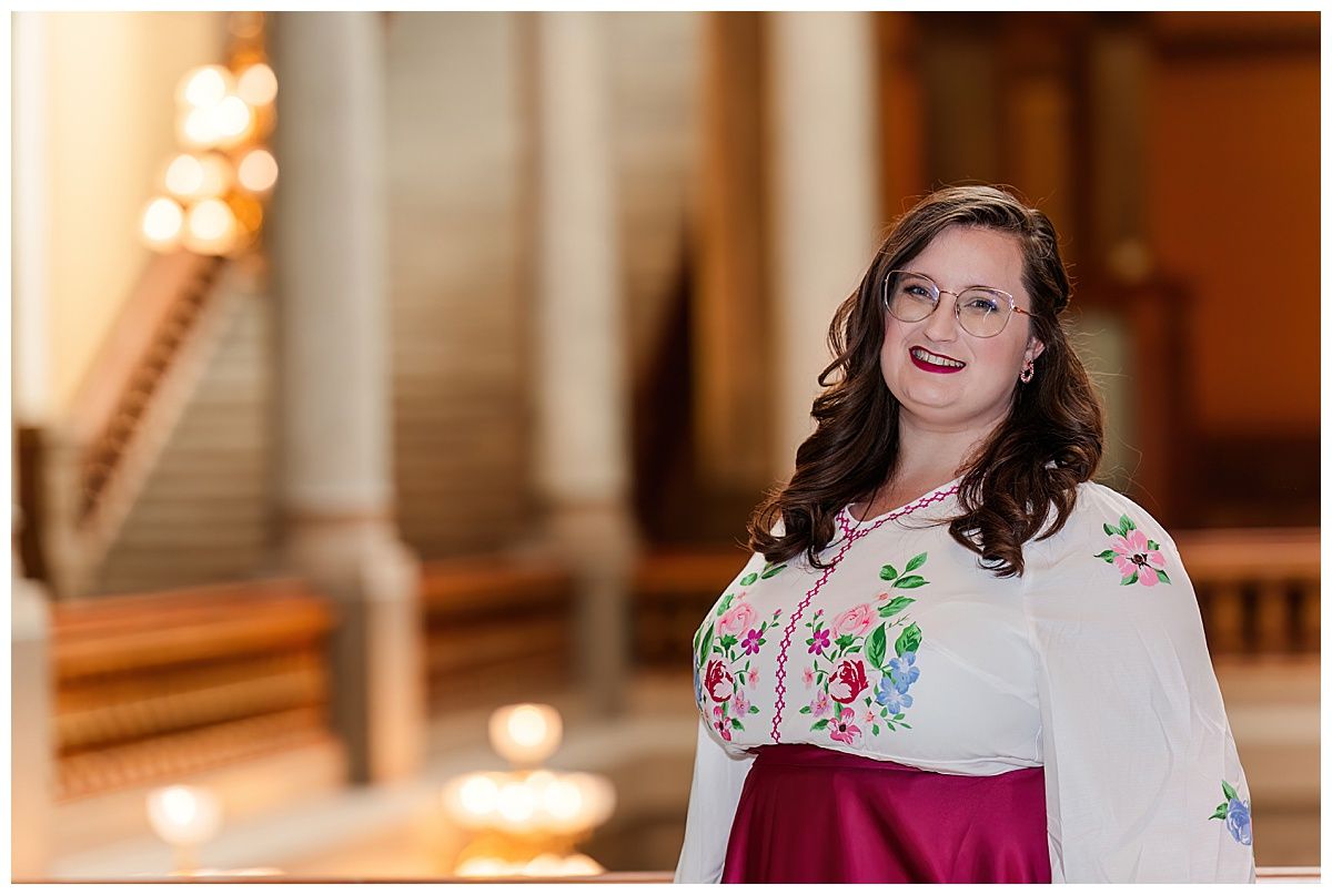 Headshot in floral dress at Indiana Statehouse