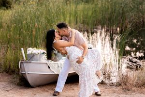 Intimate outdoor portrait session with a rustic white bathtub and natural landscape backdrop.