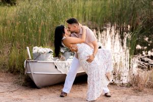Outdoor engagement photography session featuring a vintage bathtub in a rustic setting.