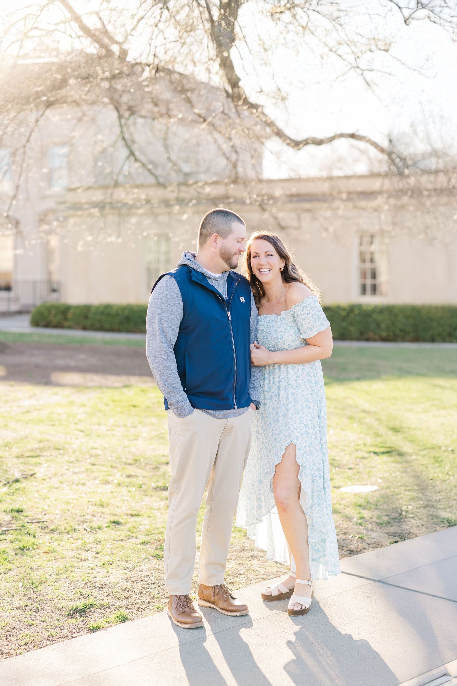 A couple shares a romantic moment together on a sunny day at the Virginia Museum of Fine Arts in Richmond, VA