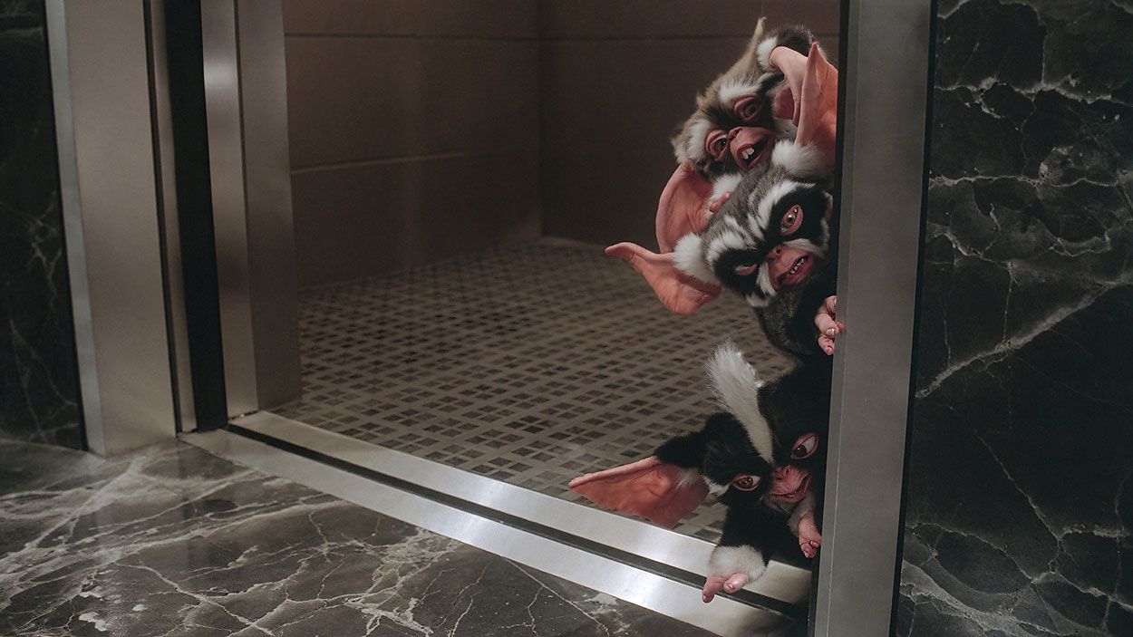Mohawk George and Lenny Mogwais exit elevator, a scene from Gremlins 2