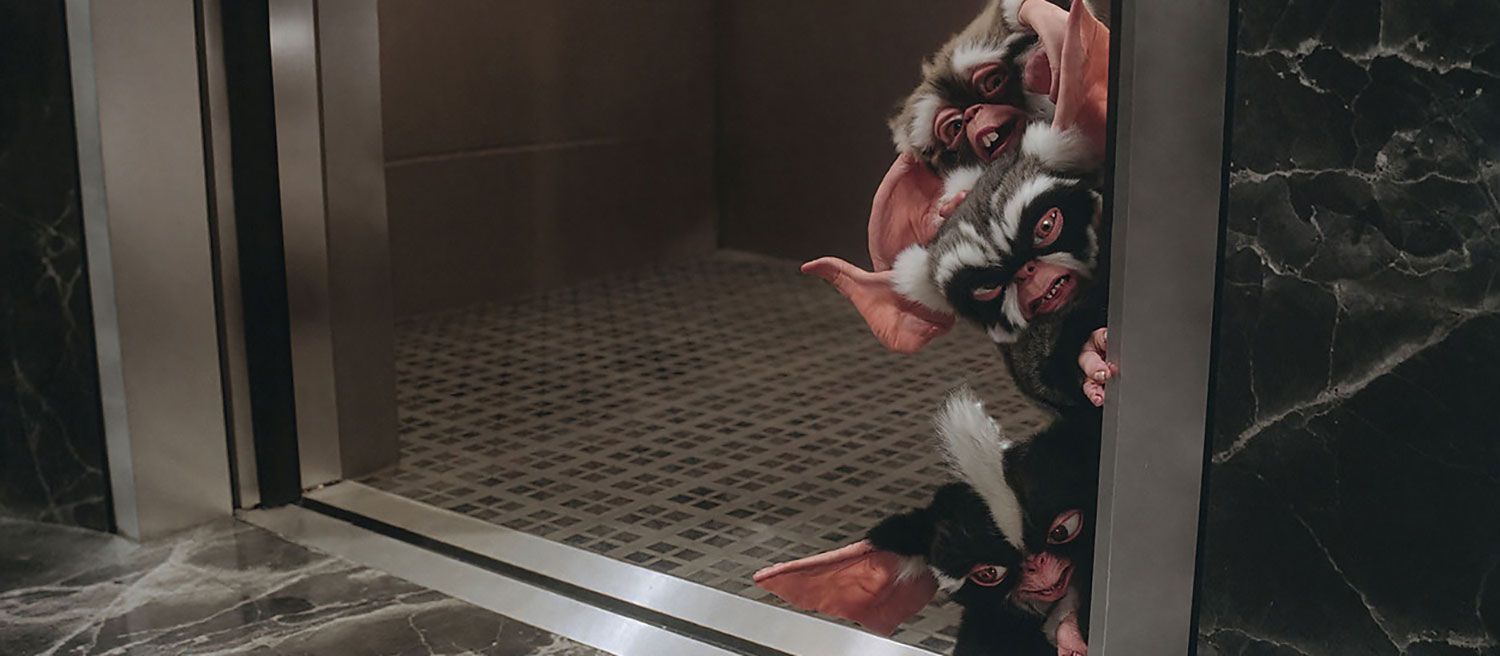 Mohawk George and Lenny Mogwais exit elevator, a scene from Gremlins 2