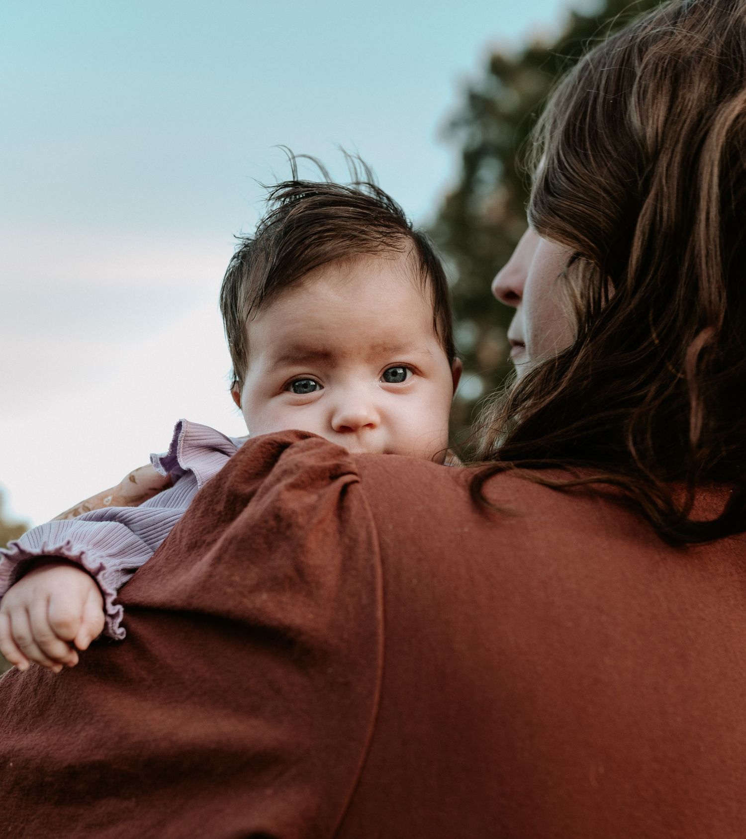 Close-up shots showing intimate family moments against blue sky.