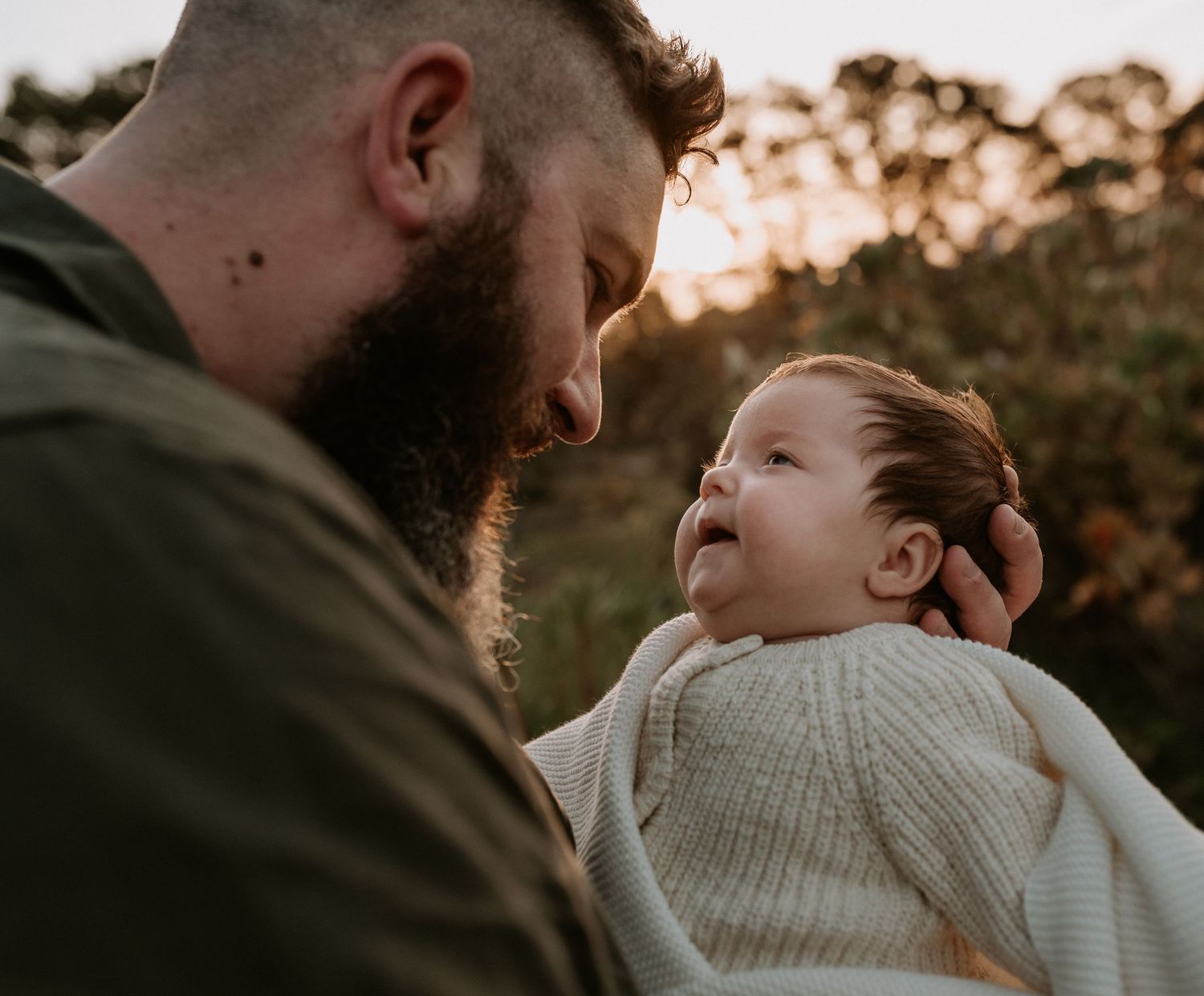 Tender family moments captured in warm evening light outdoors.