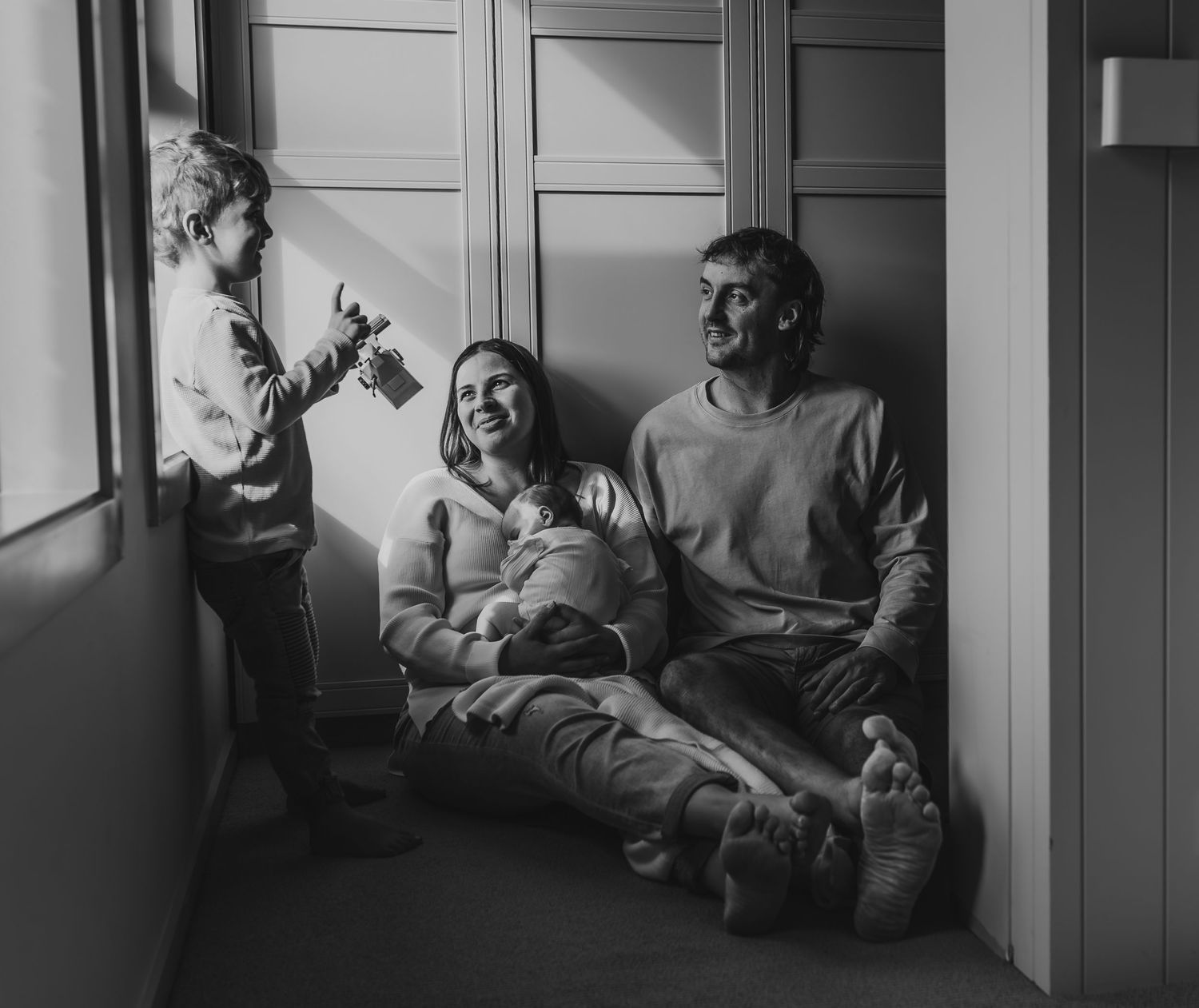 Black and white panoramic series showing family bonding moments.