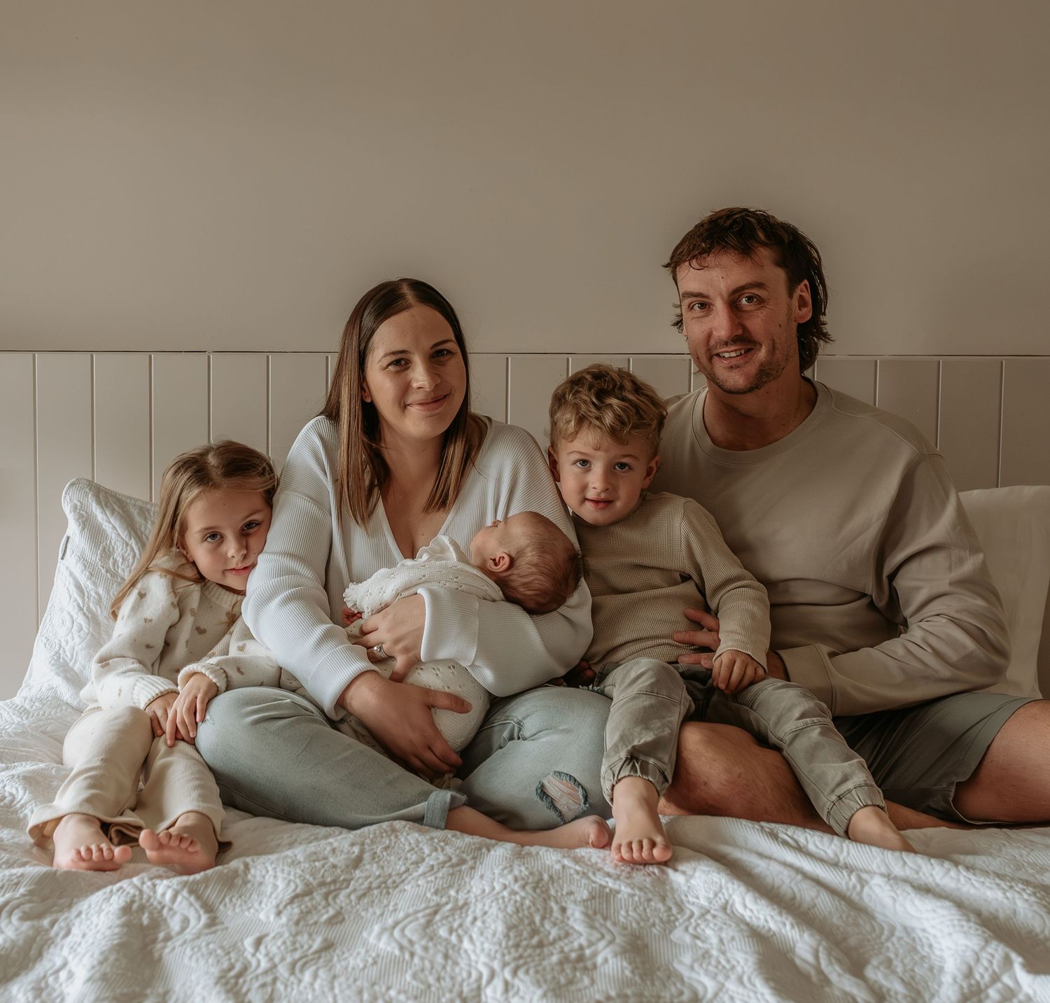 Candid lifestyle photos of family members relaxing together on a bed.