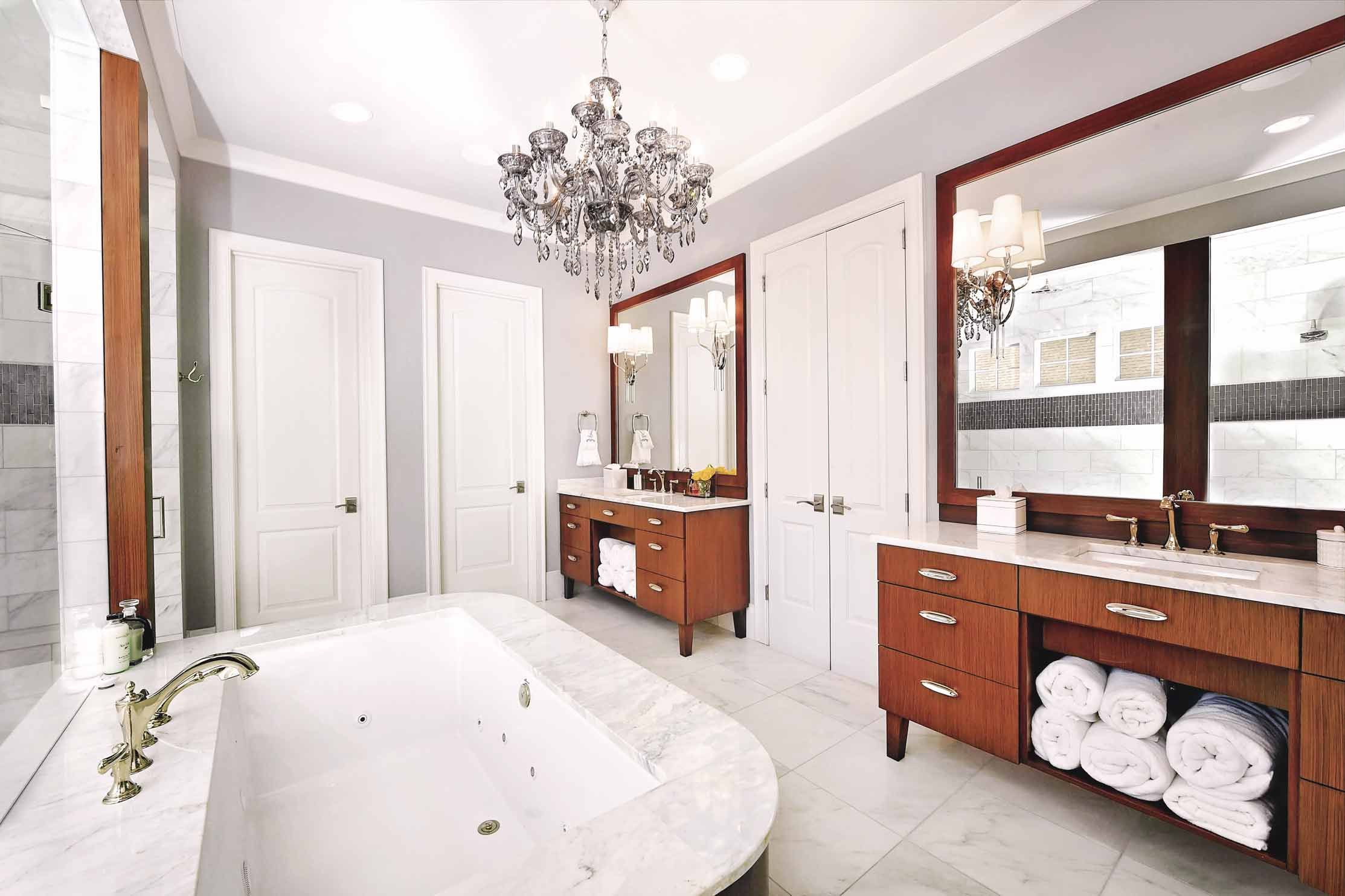 n elegant bathroom in South Park Residence, featuring a stunning chandelier that adds a touch of luxury and sophistication.