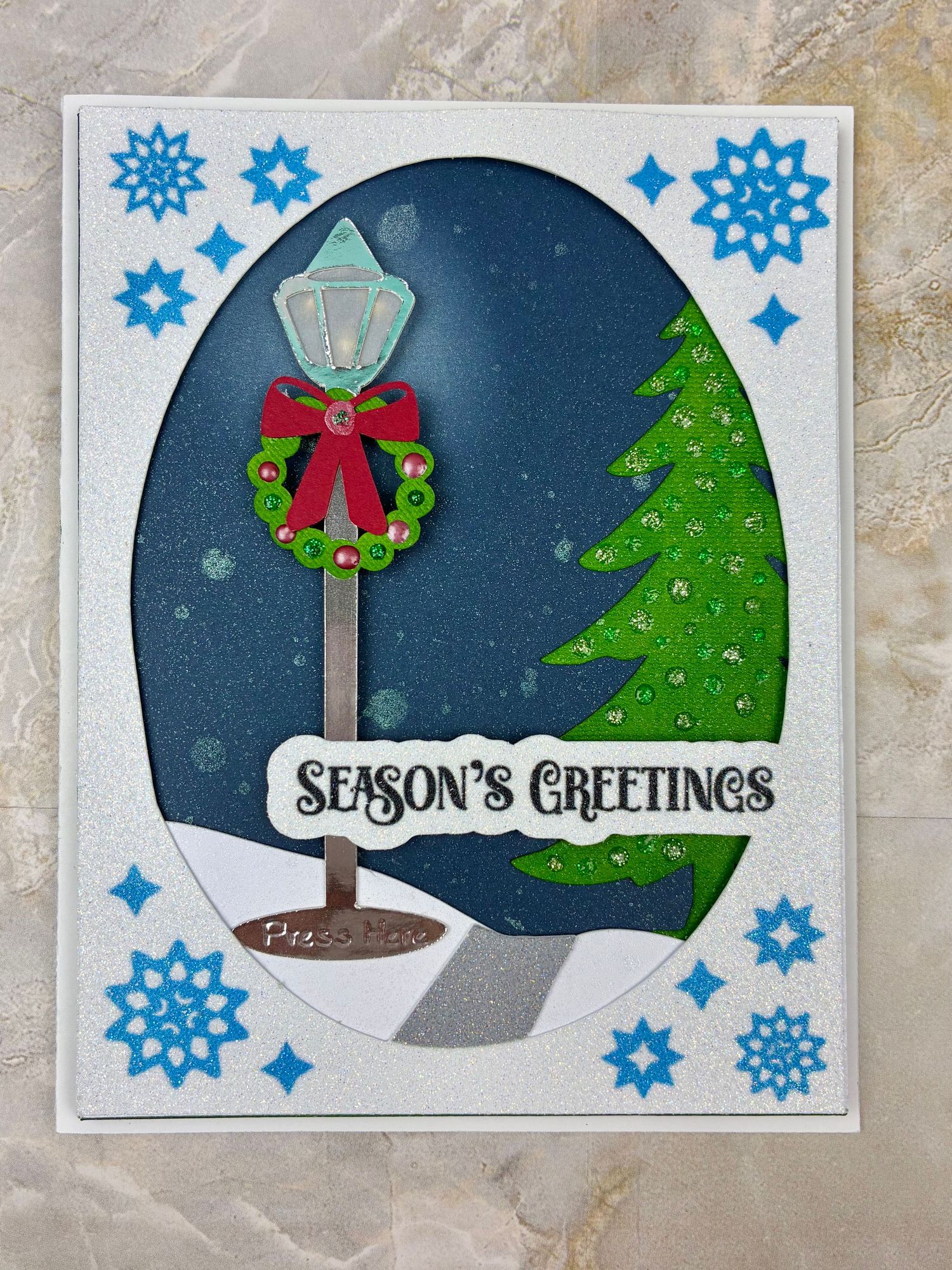 Christmas card featuring a lamppost that illuminates