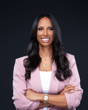 Professional headshots featuring pink blazer against dark background.
