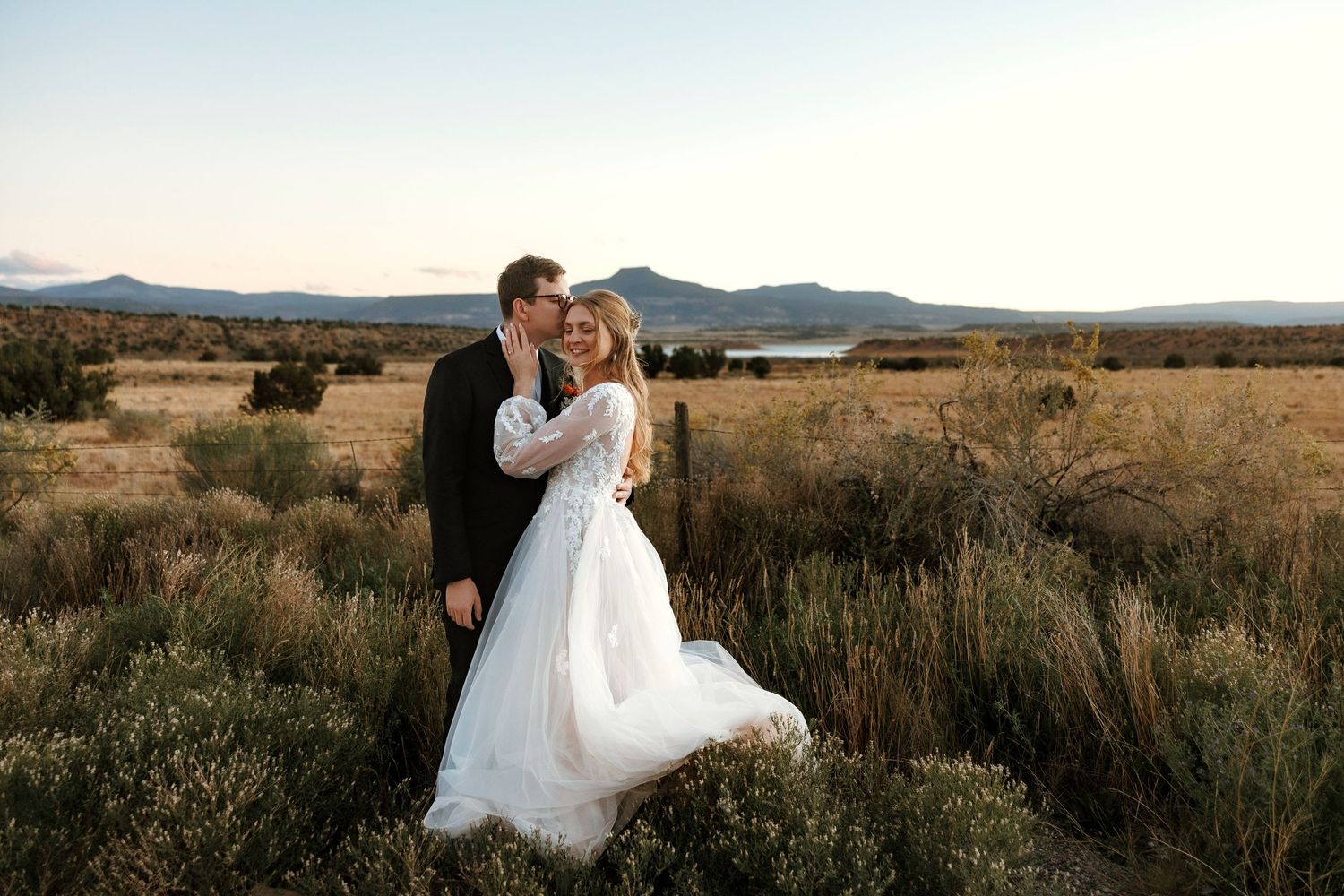Beautiful southwestern couple embracing in Abiquiu desert for engagement photo session