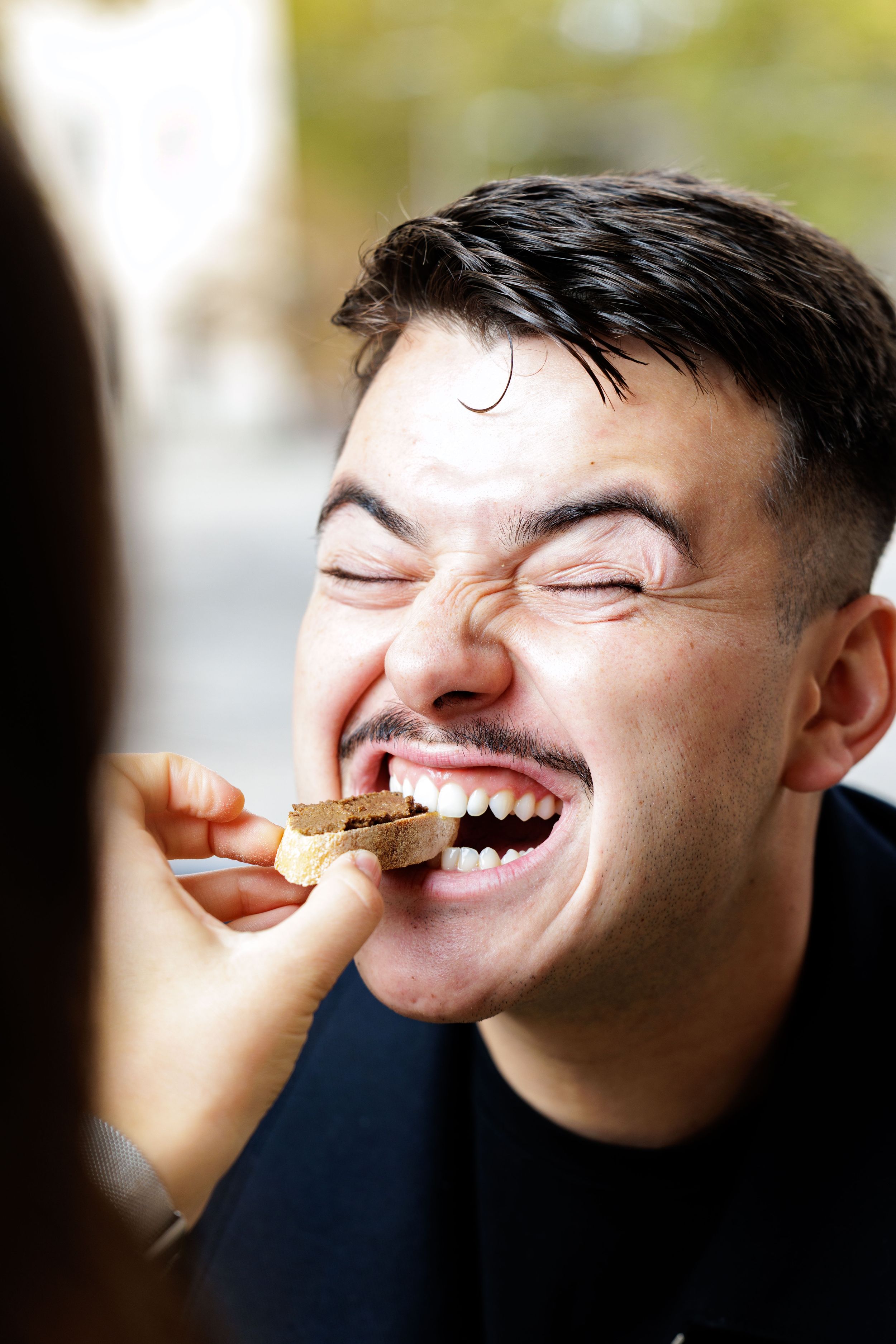 A sequence of photos shows someone laughing while balancing a cookie on their nose in playful expressions.