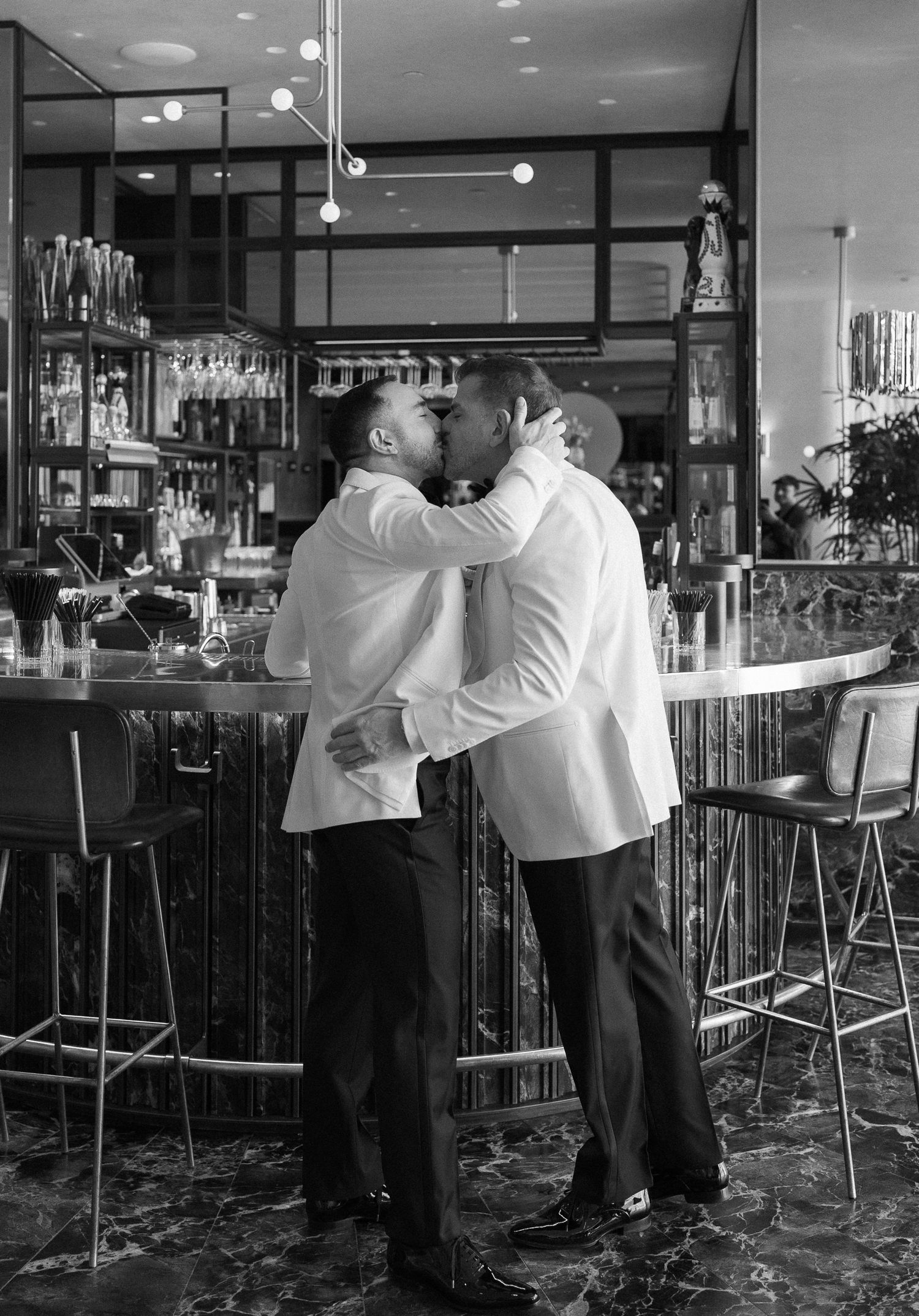 Bride and groom celebrating with guests on dance floor at lively wedding reception.