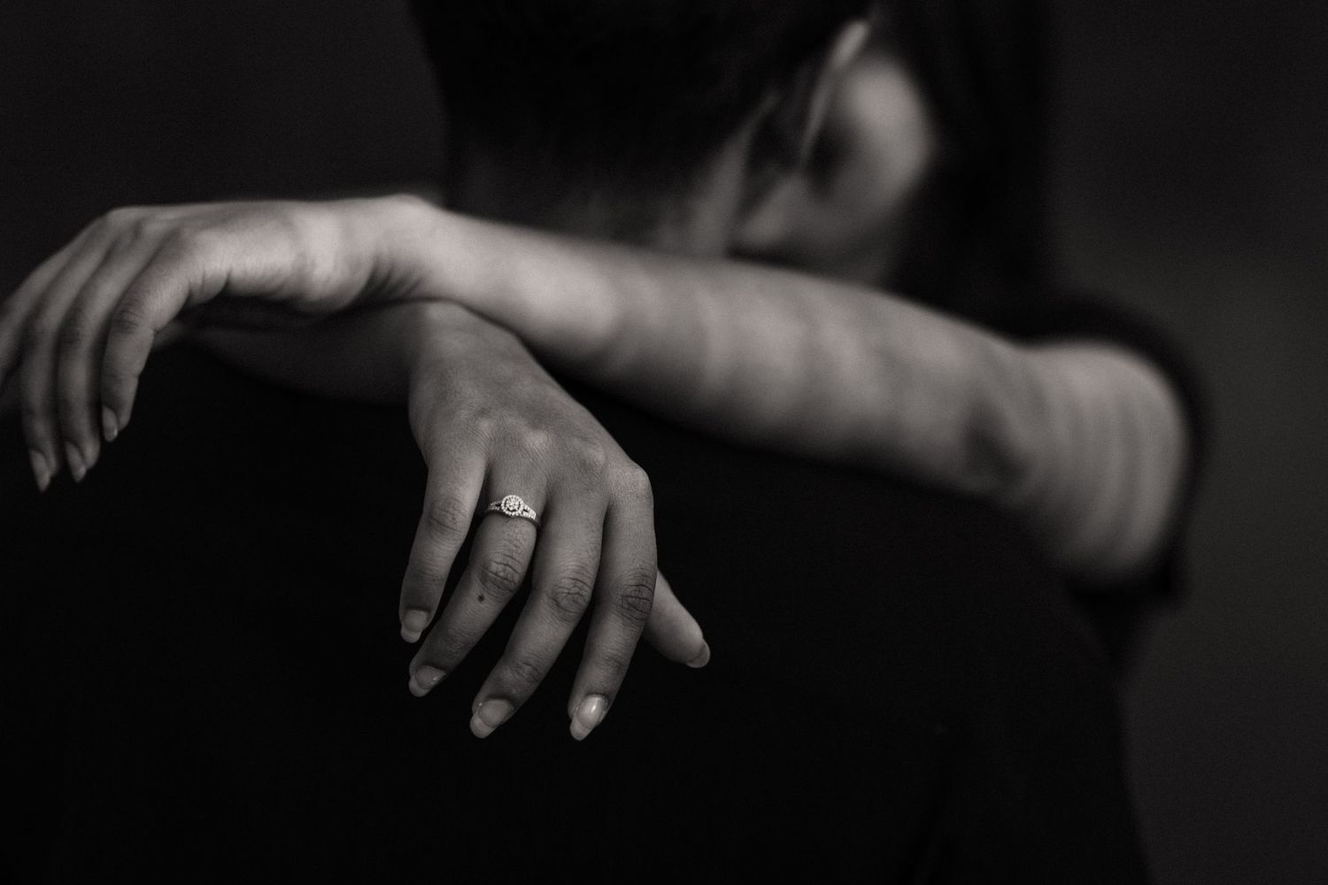 Artistic black and white close-up shots of hands and arms in dramatic lighting.