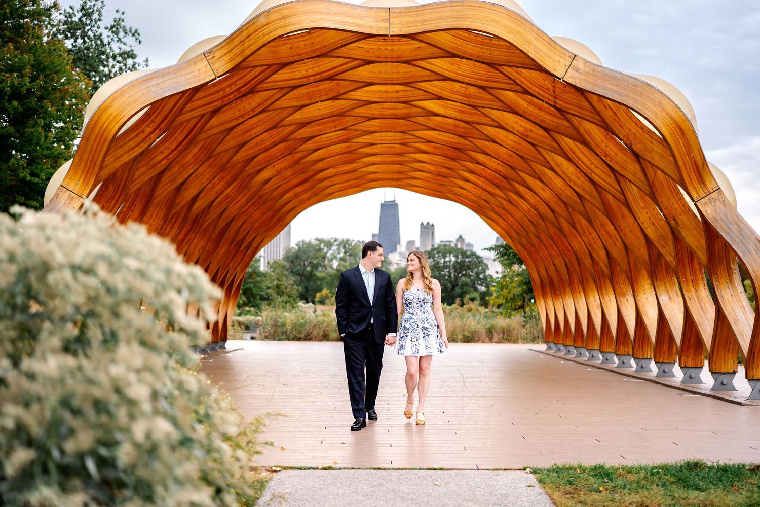 Couple relaxing in vibrant orange and yellow tulip garden during springtime golden hour.