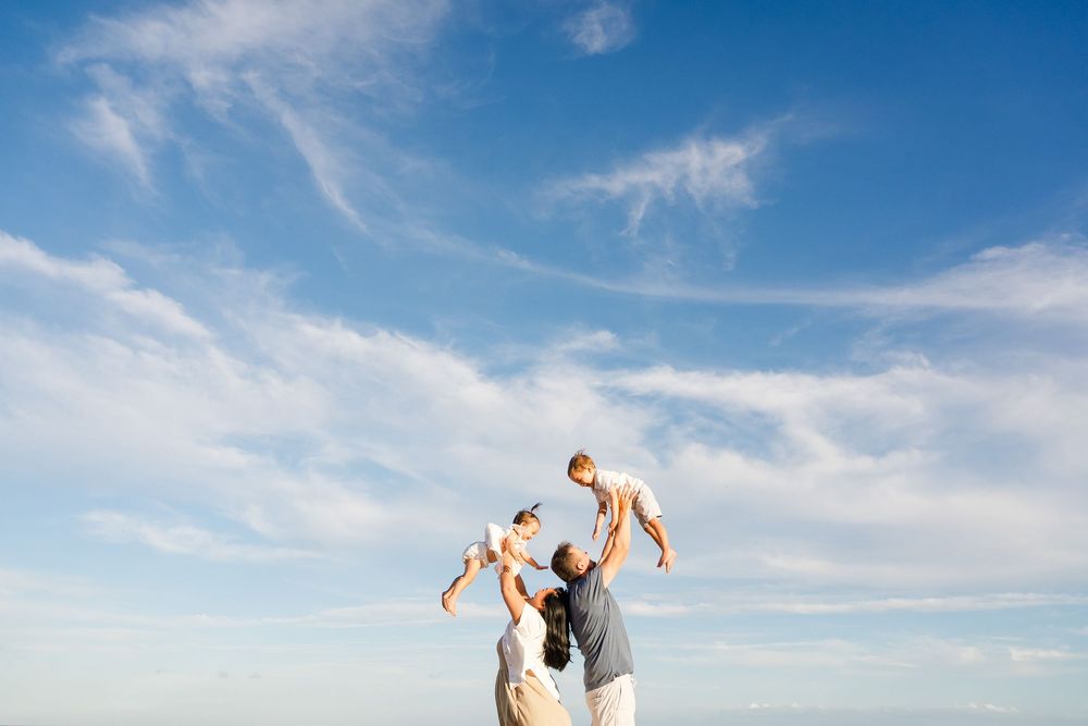 A series of wedding photos showing romantic moments between a couple against a bright blue sky background.