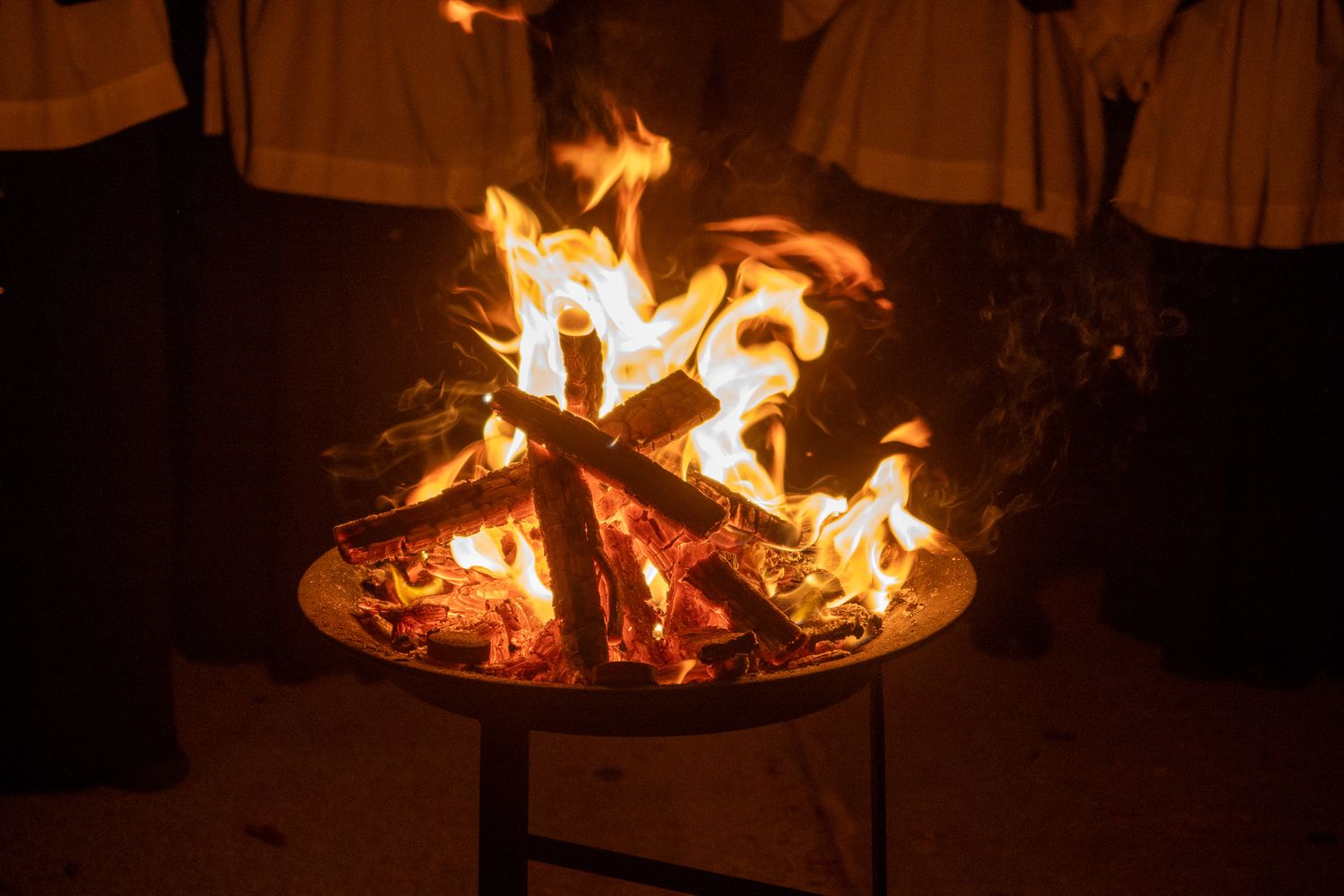 A ring of blazing fire in a cooking pan creating dramatic orange and yellow flames.