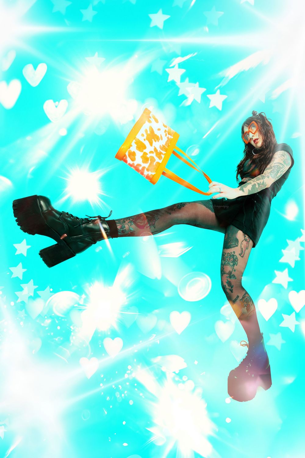 Tattooed woman in black dress kicks leg up holding cow-print bag against glowing teal background with hearts and stars.