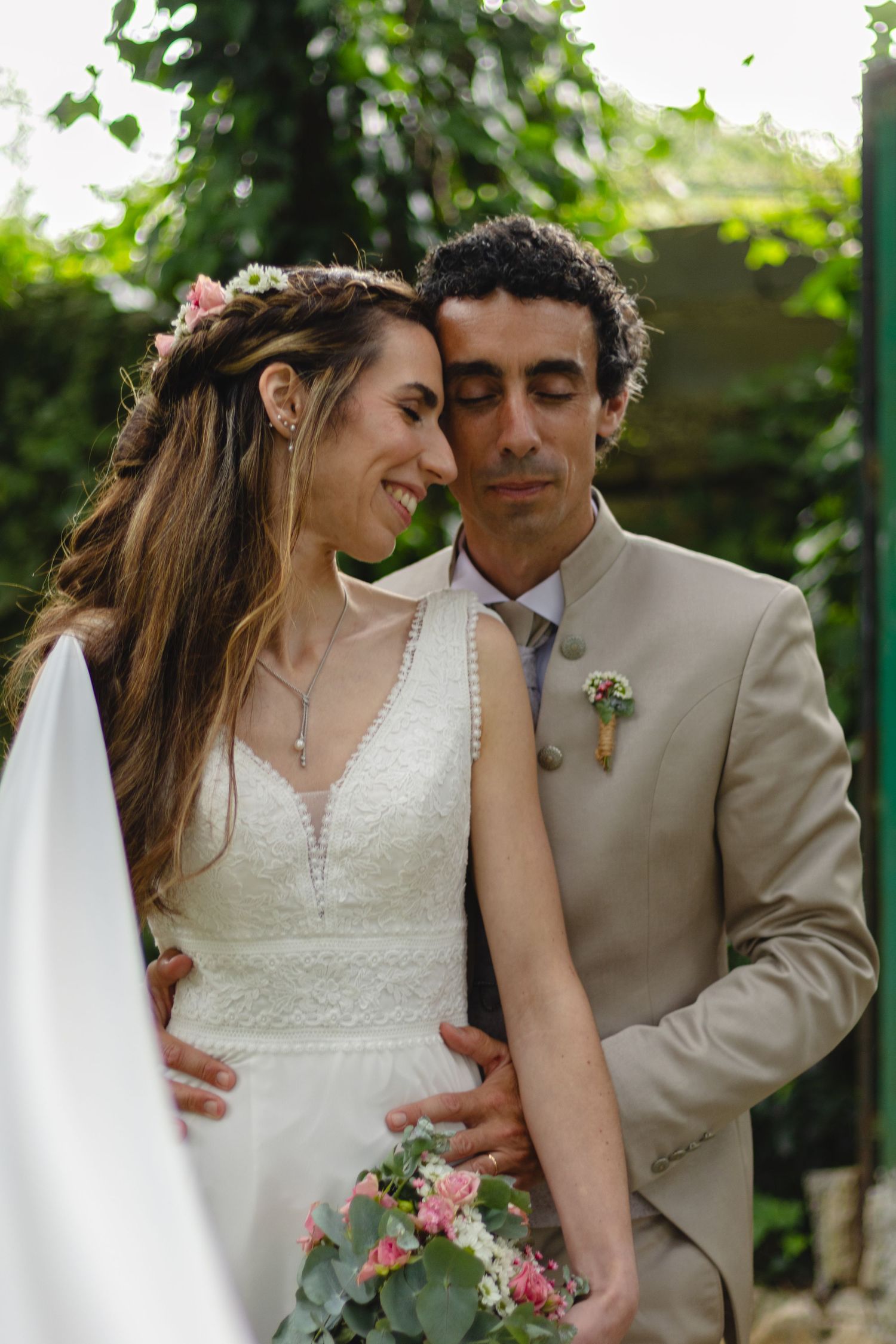 Intimate wedding portraits captured in a garden setting with soft natural lighting.