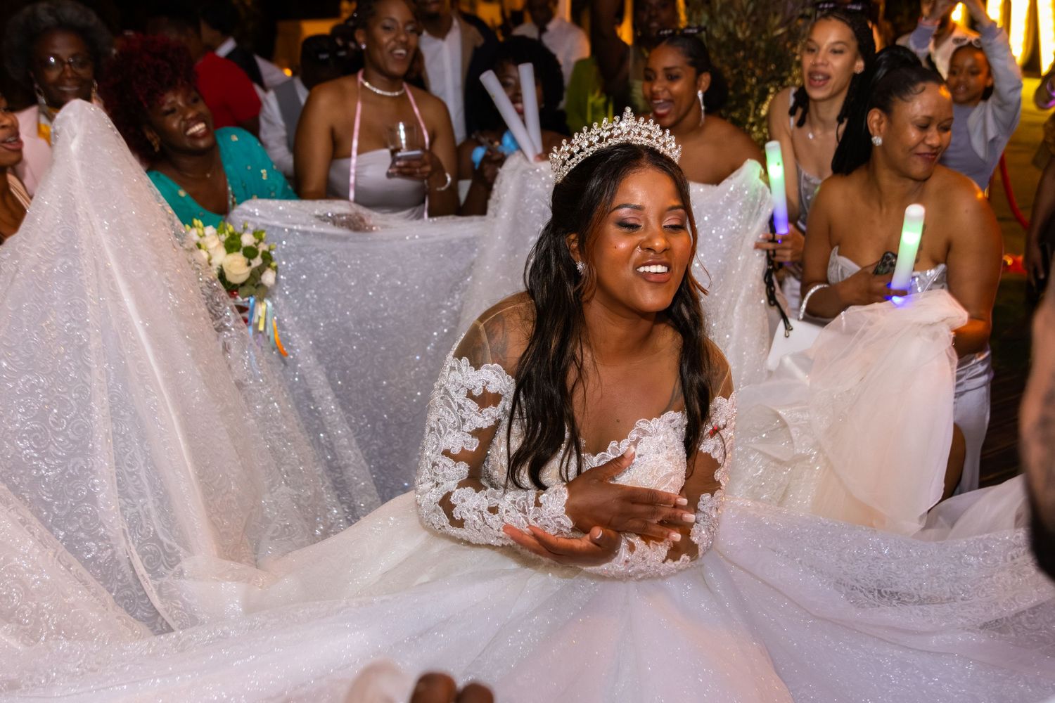 Wedding party celebrating with joyful dancing at an indoor reception.