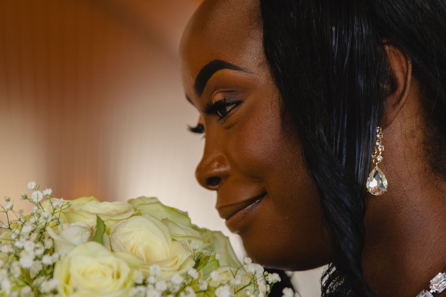 Candid wedding moments captured with floral arrangements in soft lighting.