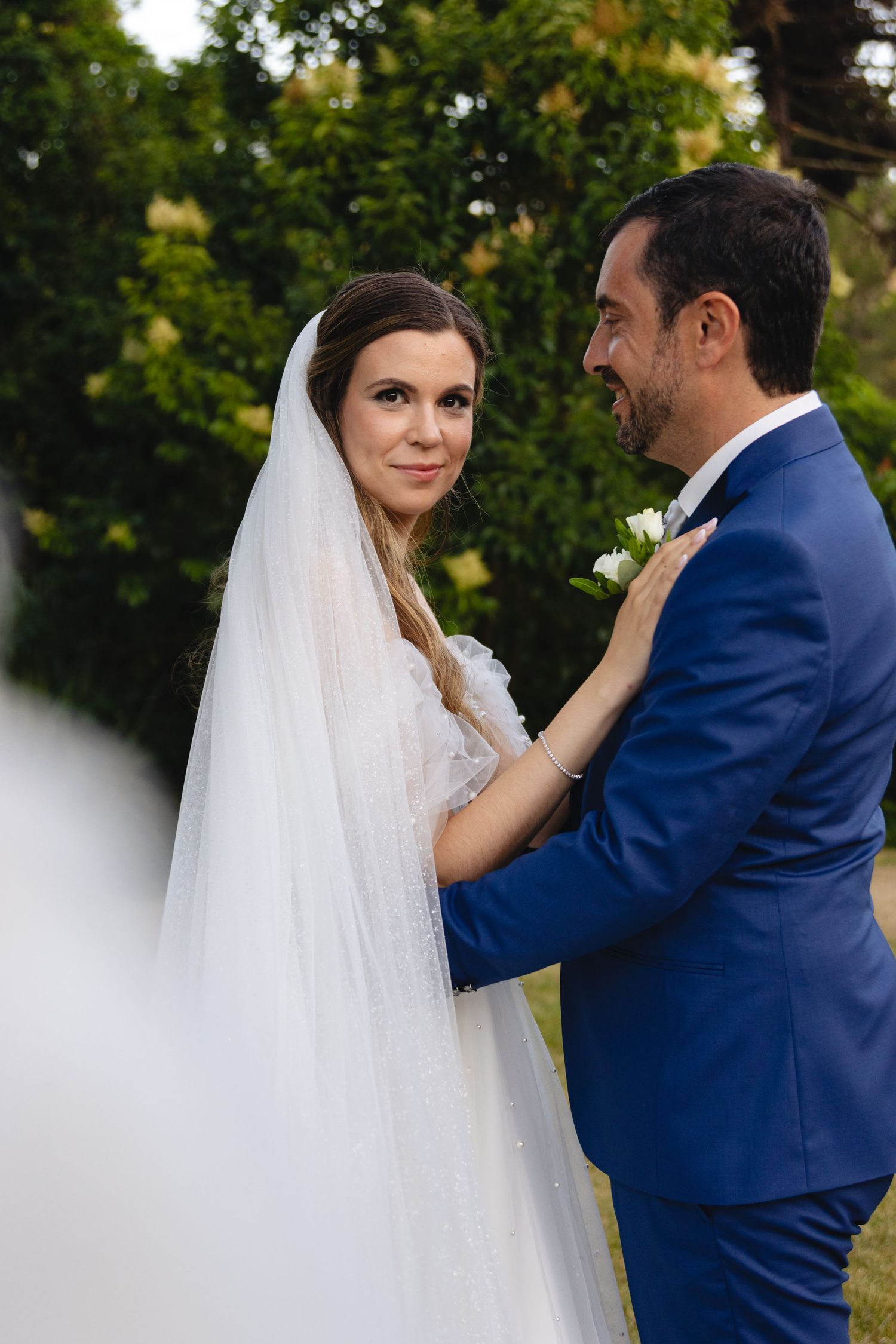 A romantic outdoor wedding photoshoot with a couple in blue and white attire.
