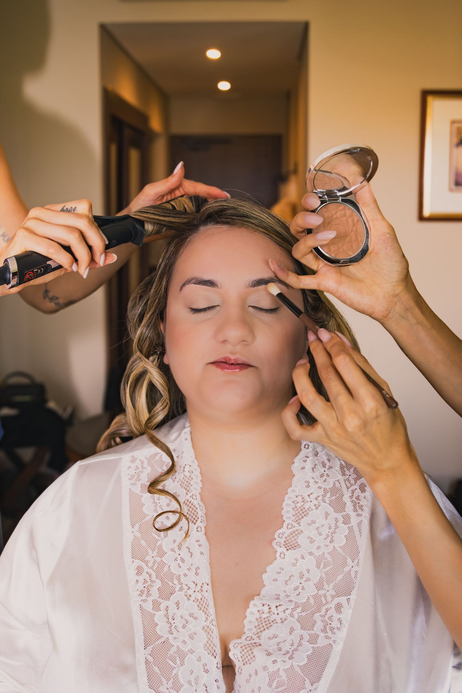 Series of shots showing professional makeup application during bridal preparation.