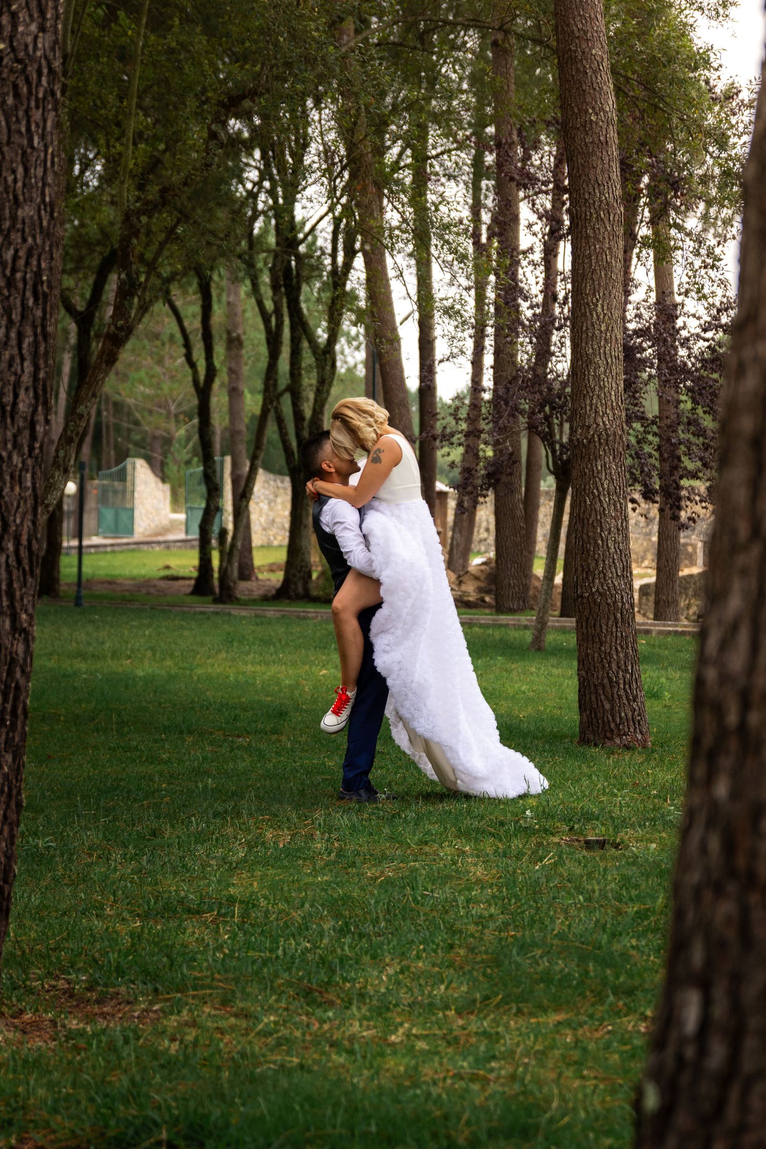 Romantic wedding photo sequence captured in wooded park setting.