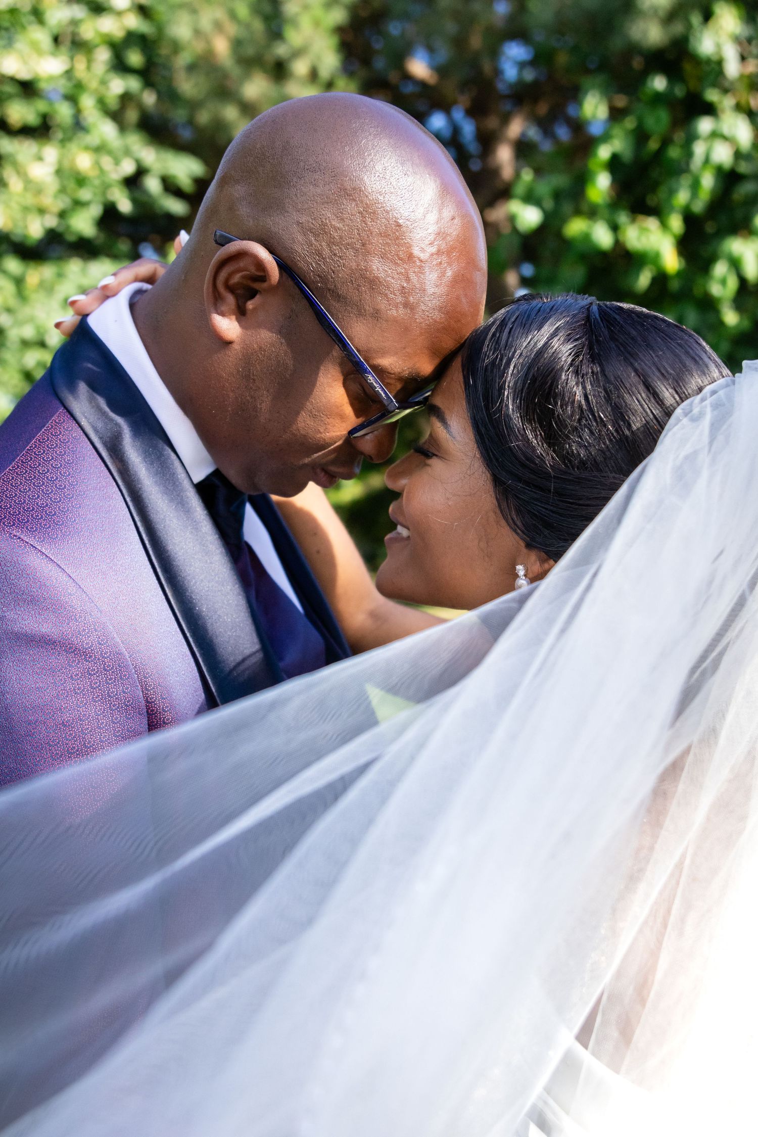 Close-up shot of a couple sharing an intimate moment during their outdoor wedding ceremony.