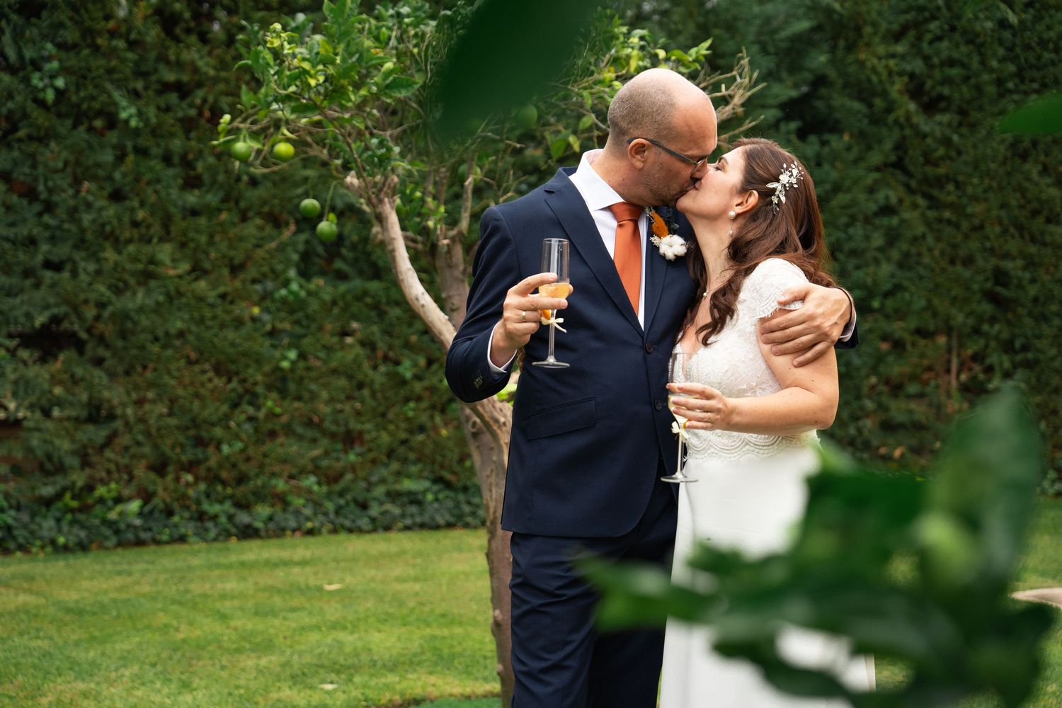 A newlywed couple embraces during their outdoor wedding photoshoot.